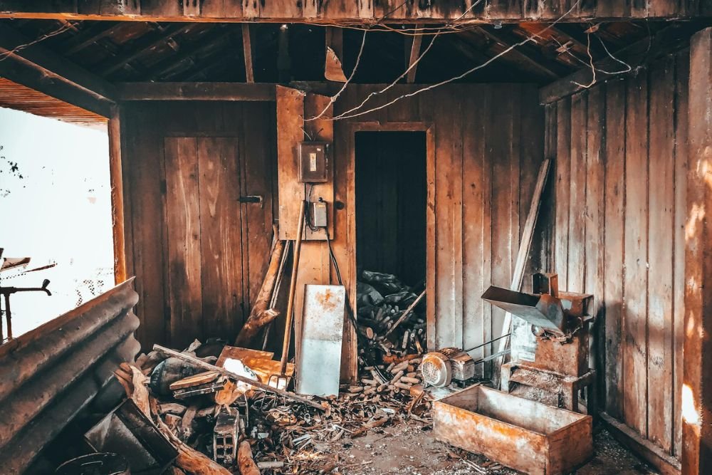 A rustic wooden cabin cluttered with tools and wood, highlighting a junk removal service in Honolulu, HI.