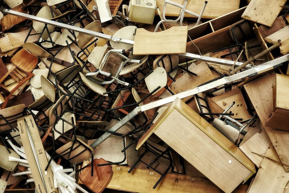 A collection of wooden furniture and assorted items ready for large-scale junk removal in Honolulu, HI.